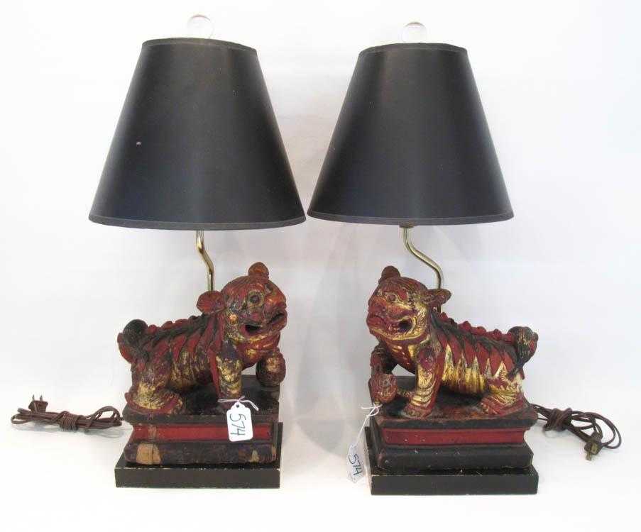 Appraisal: PAIR OF CHINESE CARVED WOOD FOO DOG TABLE LAMPS decorated