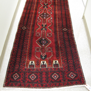 Appraisal: PERSIAN BELOUCHI TRIBAL RUNNER geometric and stylized floral design on