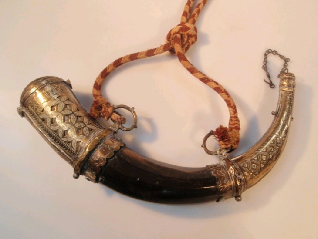 Appraisal: An Eastern powder horn with brass mounts