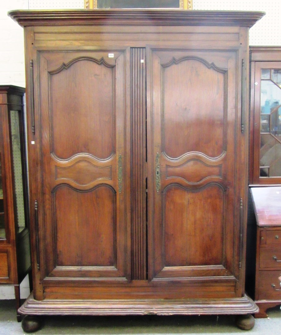 Appraisal: A th century French oak two door armoire on stile