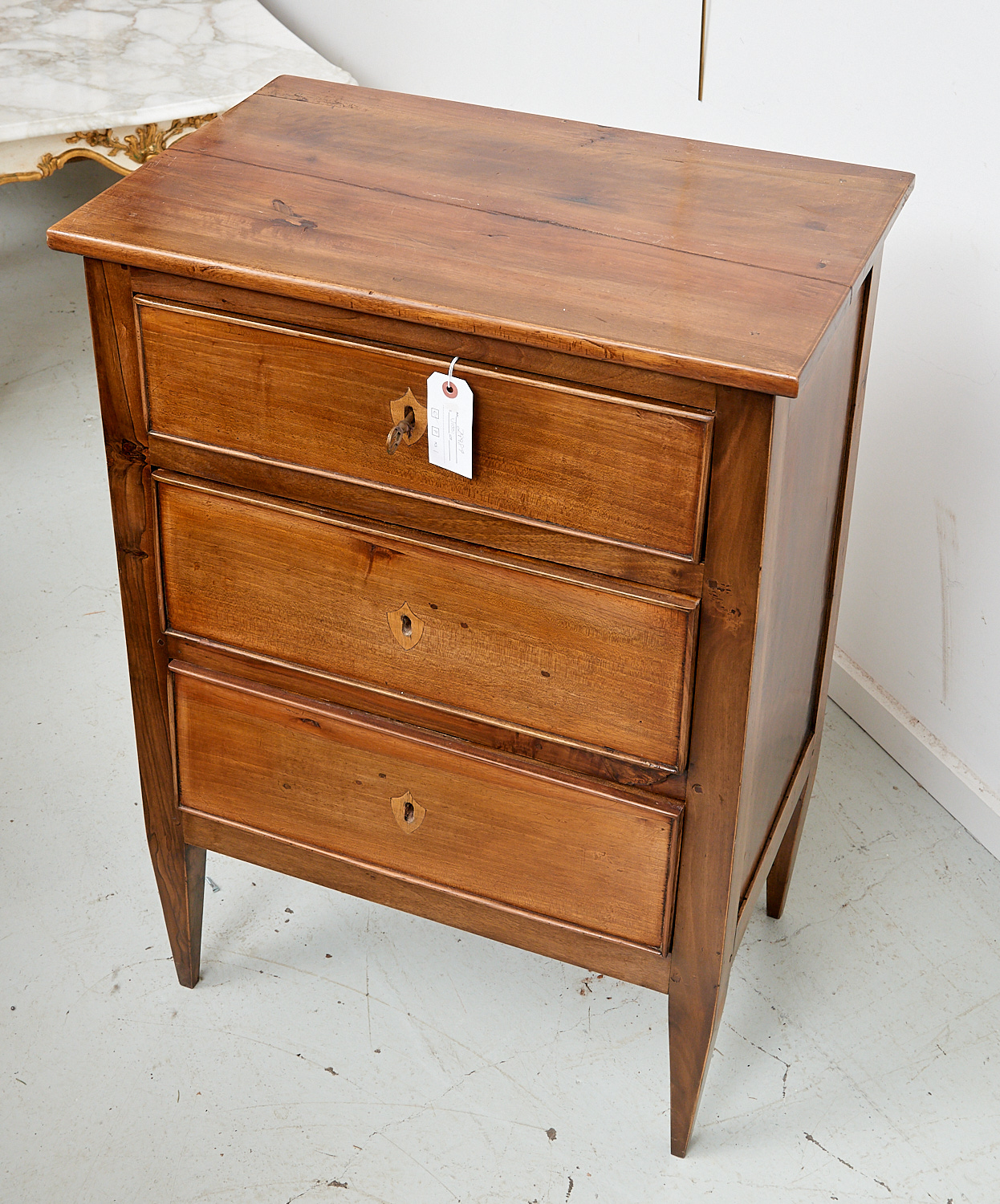 Appraisal: DIRECTOIRE STYLE PETIT COMMODE th c French rustic beechwood three-drawer