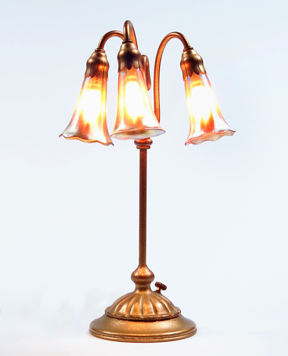 Appraisal: TIFFANY STUDIOS Three-light Lily lamp with gold Favrile glass shades