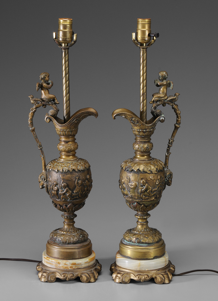 Appraisal: Pair Rennaissance Style Brass Ewers cast relief decoration with frolicking