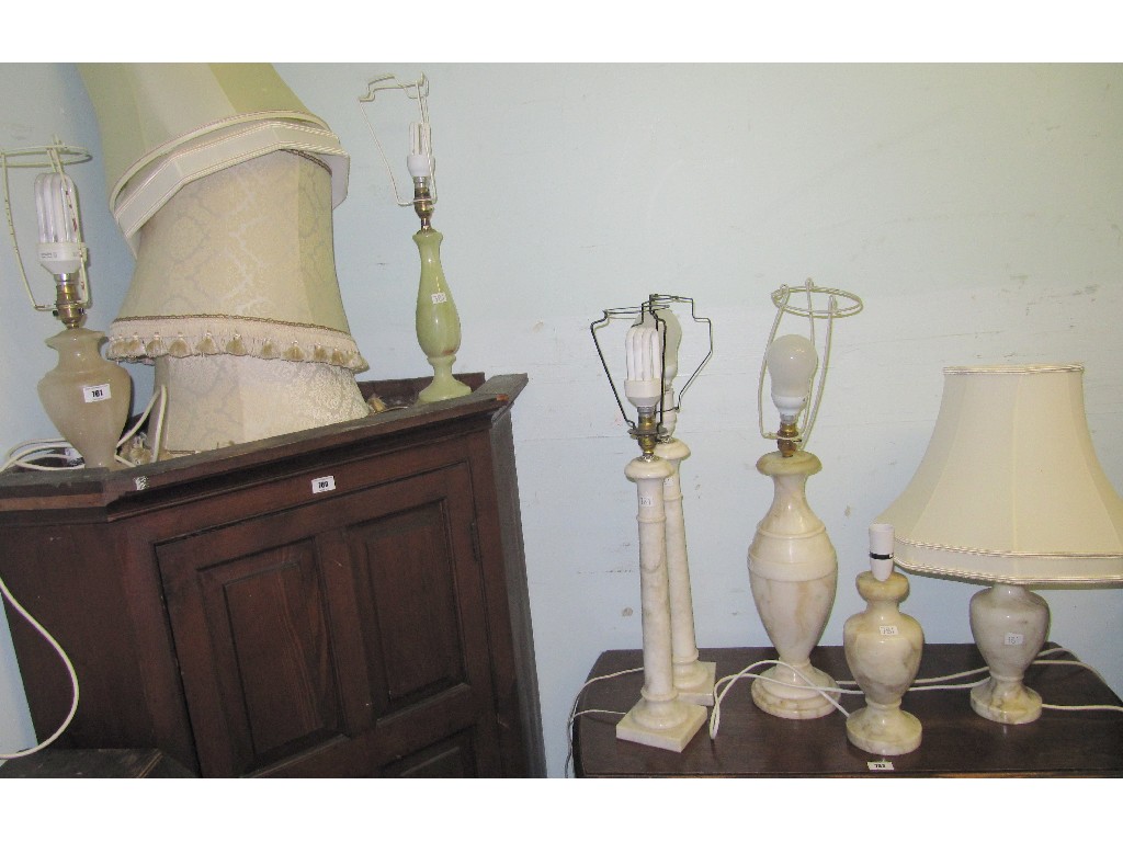 Appraisal: Lot comprising two pairs of onyx table lamps and three