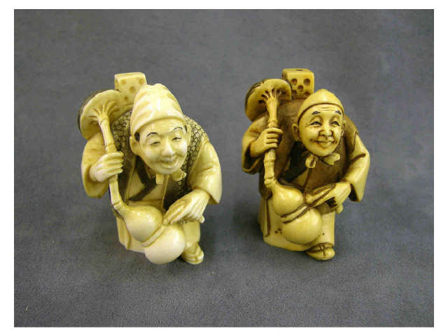 Appraisal: Two ivory netsuke each depicting a salesman with a mask