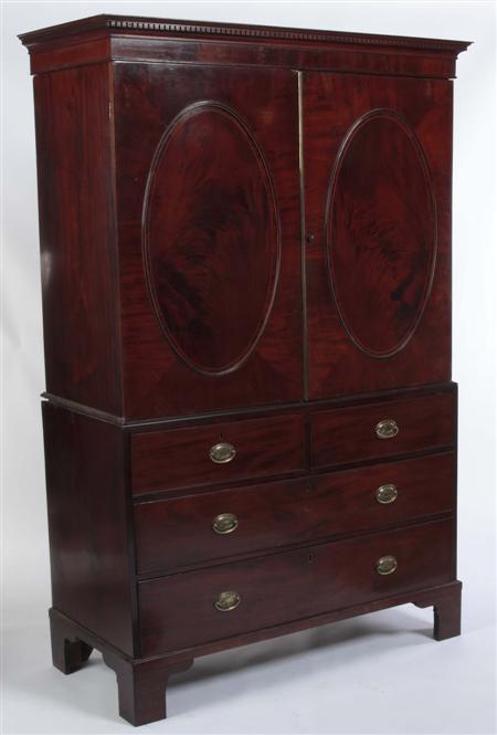 Appraisal: A Regency mahogany and crossbanded linen press the projecting cornice