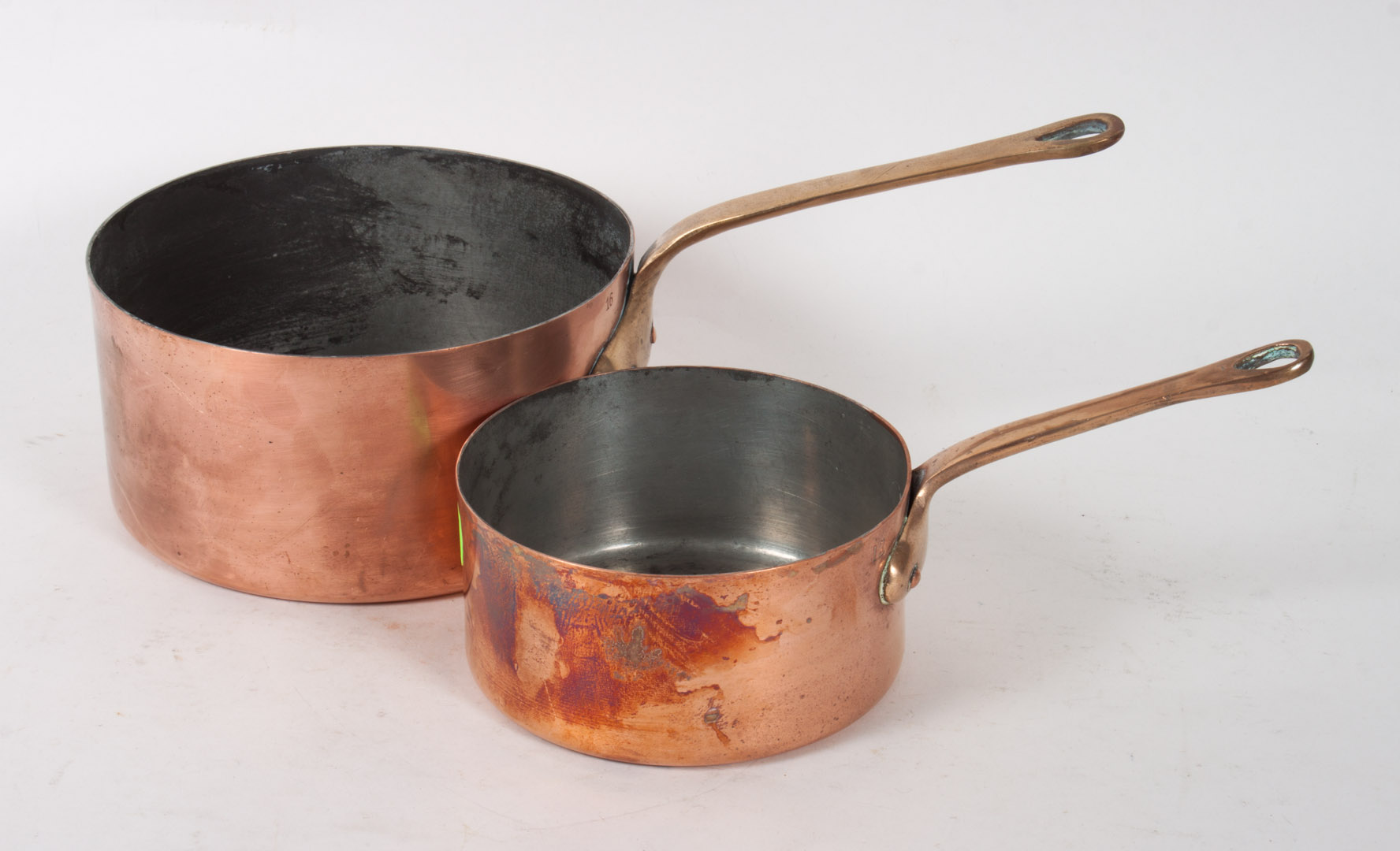 Appraisal: Two French copper and brass sauce pans copper bodies with