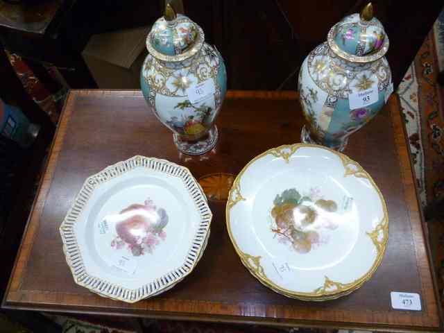 Appraisal: A PAIR OF CONTINENTAL PORCELAIN VASES AND COVERS decorated with