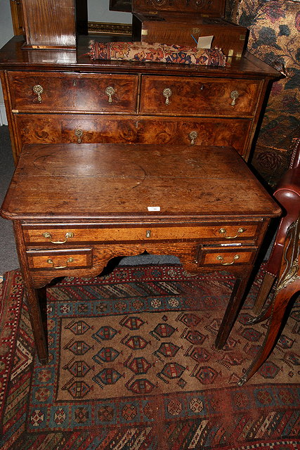 Appraisal: A TH CENTURY OAK AND MAHOGANY CROSSBANDED LOWBOY fitted three