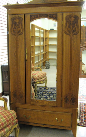 Appraisal: CARVED OAK SINGLE-DOOR WARDROBE Art Nouveau influence English c the