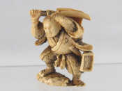 Appraisal: A stained ivory netsuke of a warrior ht cm Circa