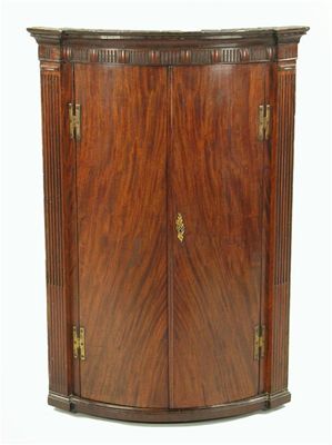 Appraisal: A George III mahogany bowfront hanging corner cupboard the interior