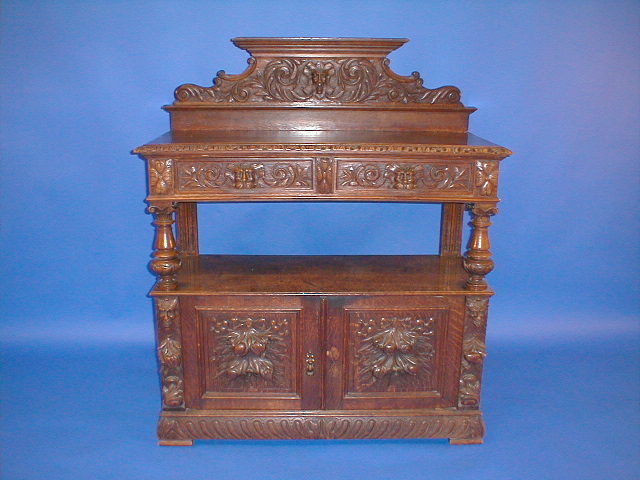 Appraisal: A late Victorian carved oak buffet with lion mask drawer