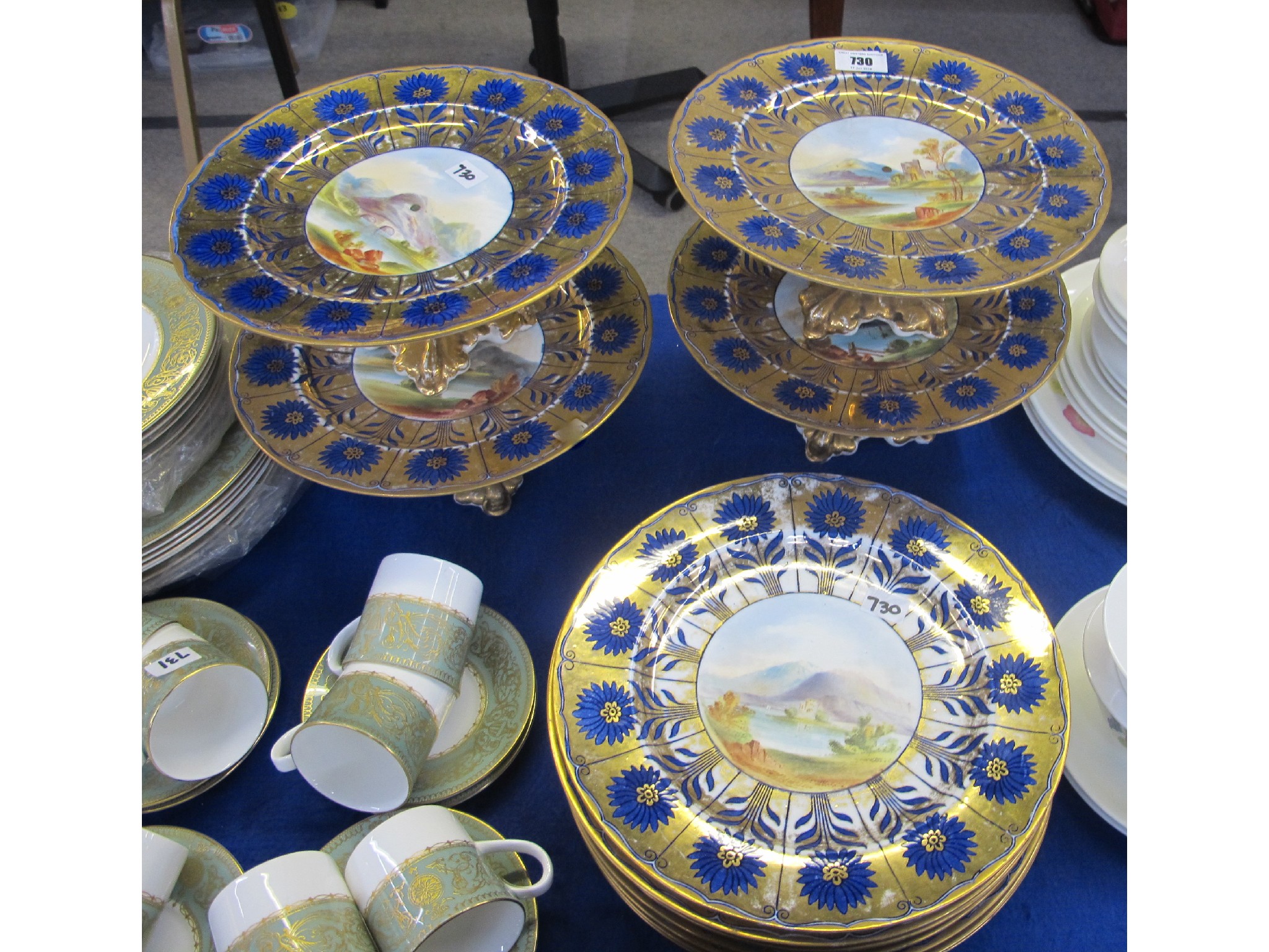 Appraisal: Eight piece porcelain dessert service with gilt borders and landscape