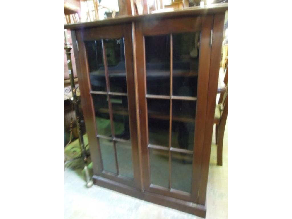 Appraisal: An Edwardian walnut side cabinet enclosed by a pair of