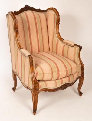 Appraisal: A French walnut framed wing back armchair the moulded frame