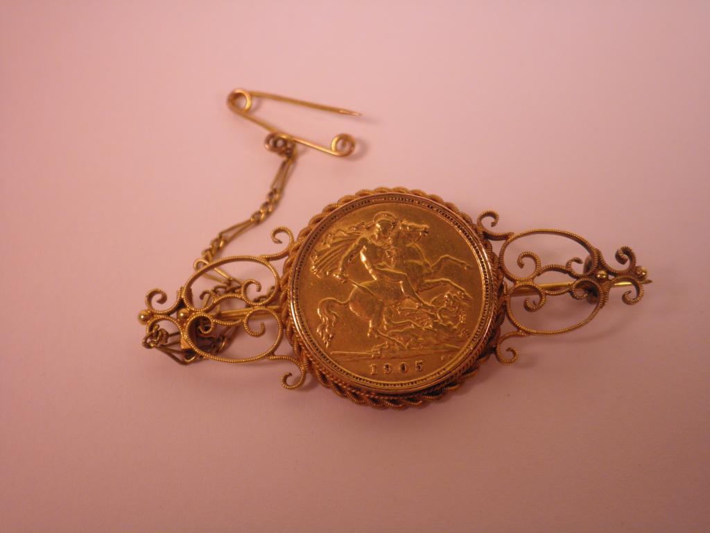 Appraisal: A gold brooch inset with a half sovereign