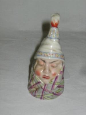 Appraisal: A ROYAL WORCESTER PORCELAIN CANDLE SNUFFER modelled as a male