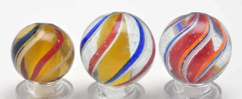 Appraisal: Lot of Solid Core Swirl Marbles Description The smallest is