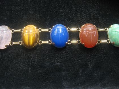 Appraisal: karat yellow gold and semi-precious stone scarab flexible bracelet Seven