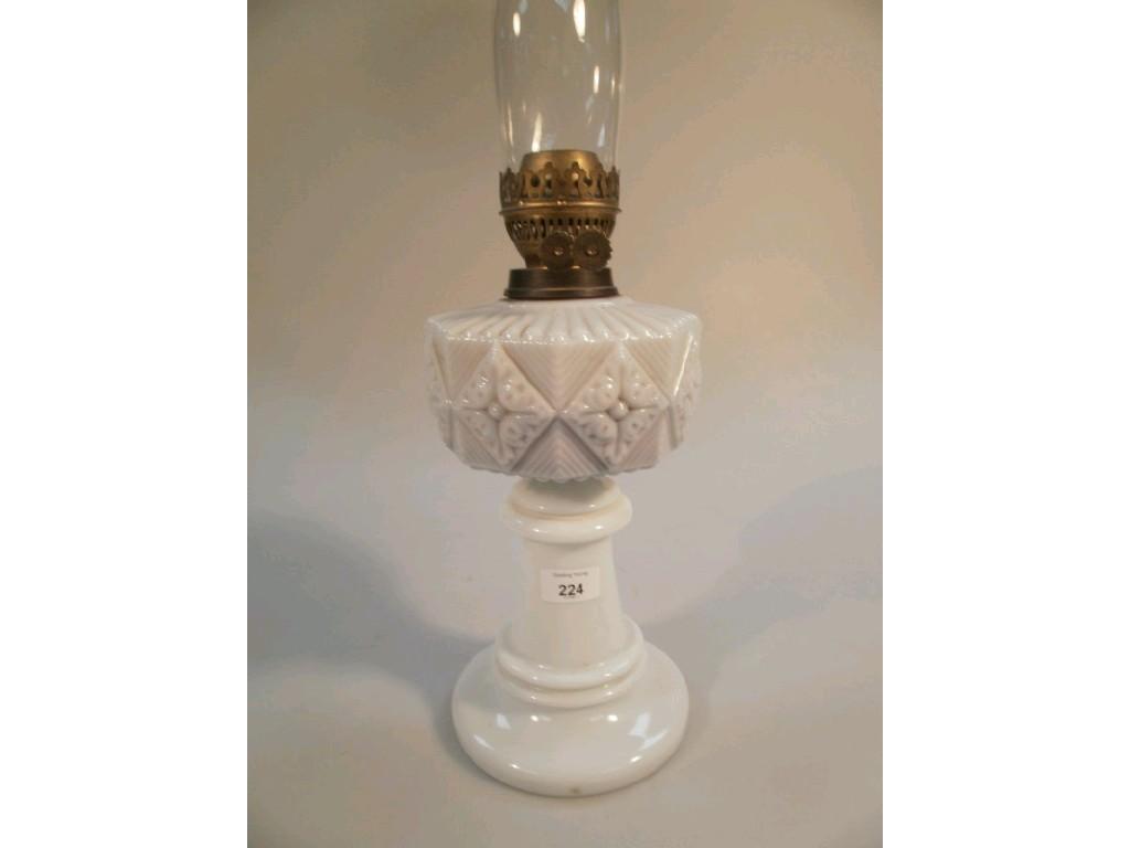 Appraisal: A Victorian opaque glass oil lamp with moulded detail with