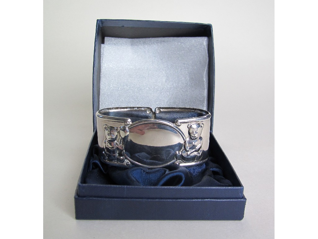 Appraisal: Hallmarked Edinburgh silver napkin ring with embossed teddy bear decoration