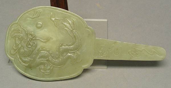 Appraisal: A carved jade fan Each side carved in low relief