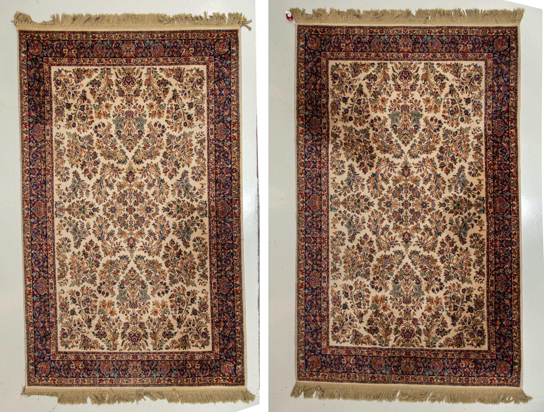 Appraisal: TWO KARASTAN IVORY SAROUK MACHINE MADE RUGS x wool pile