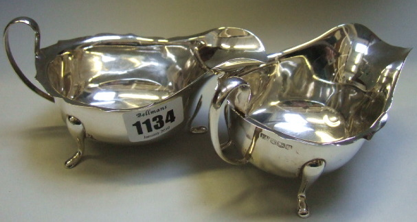 Appraisal: A pair of silver sauce boats each with a shaped