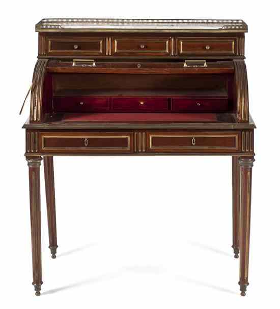 Appraisal: A Directoire Style Cylinder Desk having a captured marble top