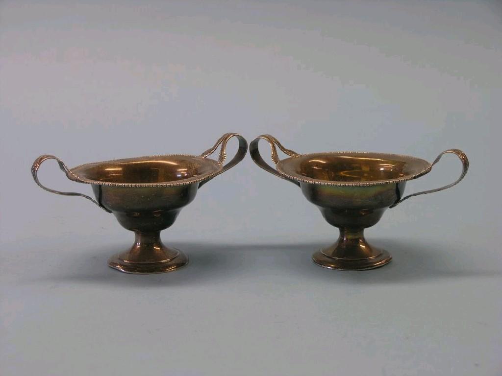 Appraisal: A pair of silver pedestal dishes each two-handled with cast