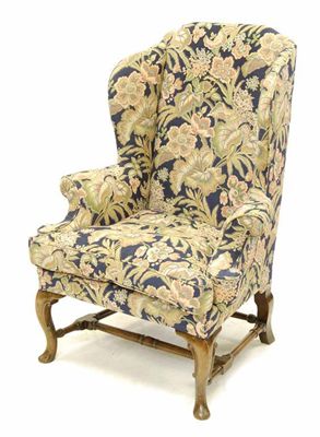 Appraisal: A walnut wing armchair in early th century style on