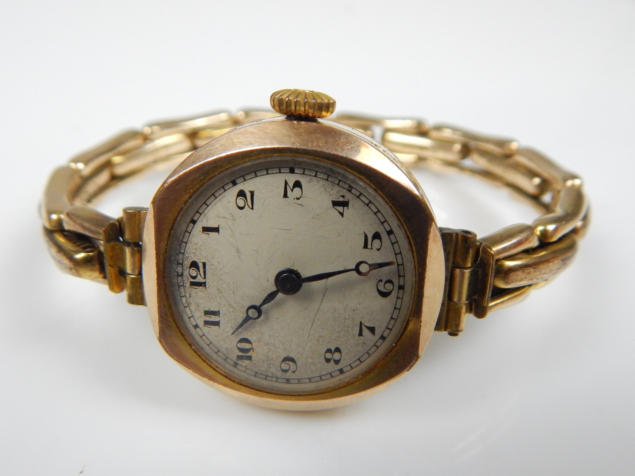 Appraisal: A wristwatch with circular white enamel dial with yellow metal