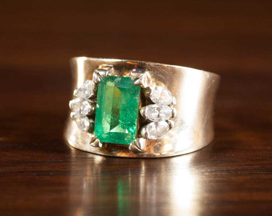 Appraisal: EMERALD DIAMOND AND FOURTEEN KARAT GOLD RING The wide yellow