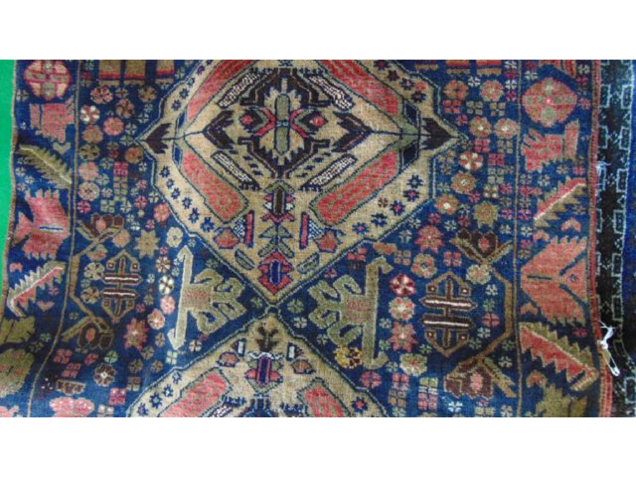 Appraisal: An eastern wool rug with a dark blue ground and