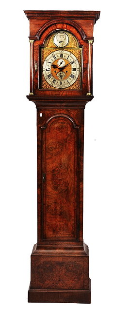 Appraisal: AN TH CENTURY WALNUT LONGCASE CLOCK the arched brass dial