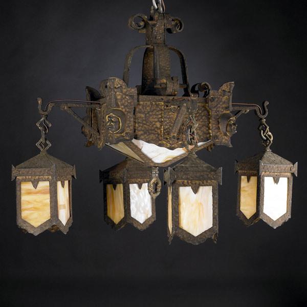 Appraisal: ARTS AND CRAFTS Iron chandelier with four monk heads and