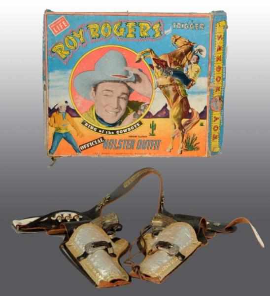 Appraisal: Roy Rogers Double Holster Gun Set Description Gold and silver