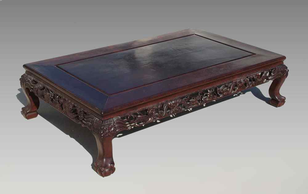 Appraisal: A LOW INDONESIAN CARVED MAHOGANY TABLE '' tall x ''