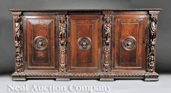 Appraisal: A Monumental Antique Italian Carved Walnut Sacristy Cupboard the top