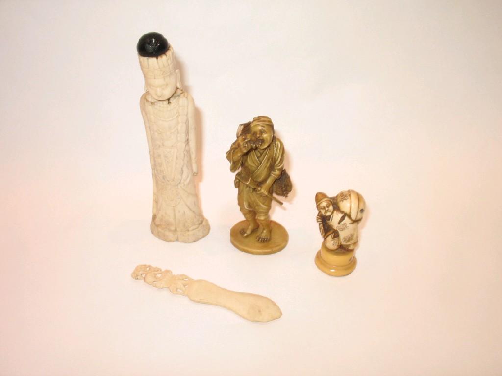 Appraisal: A JAPANESE IVORY OKIMONO of a man eating grapes Meiji