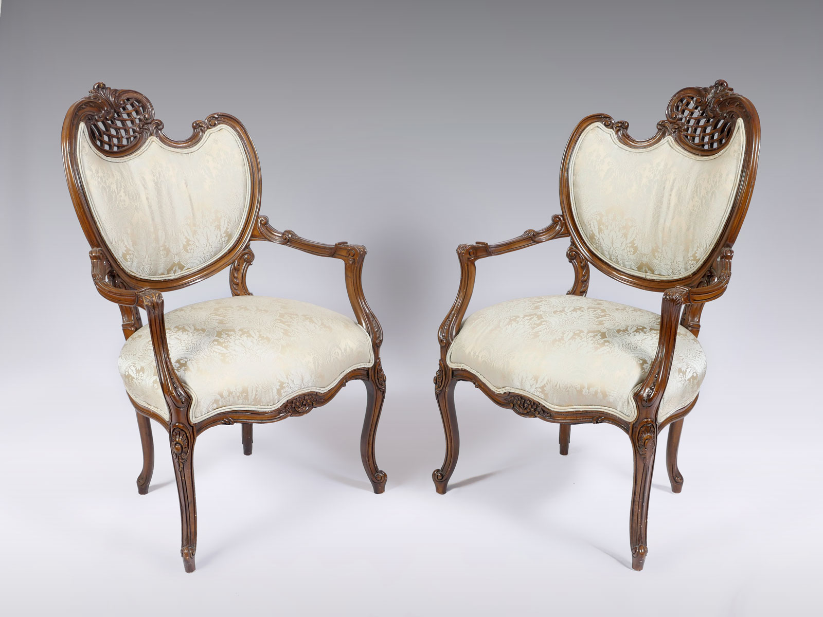 Appraisal: PAIR CARVED FRENCH ARMCHAIRS French armchairs having a pierced crest