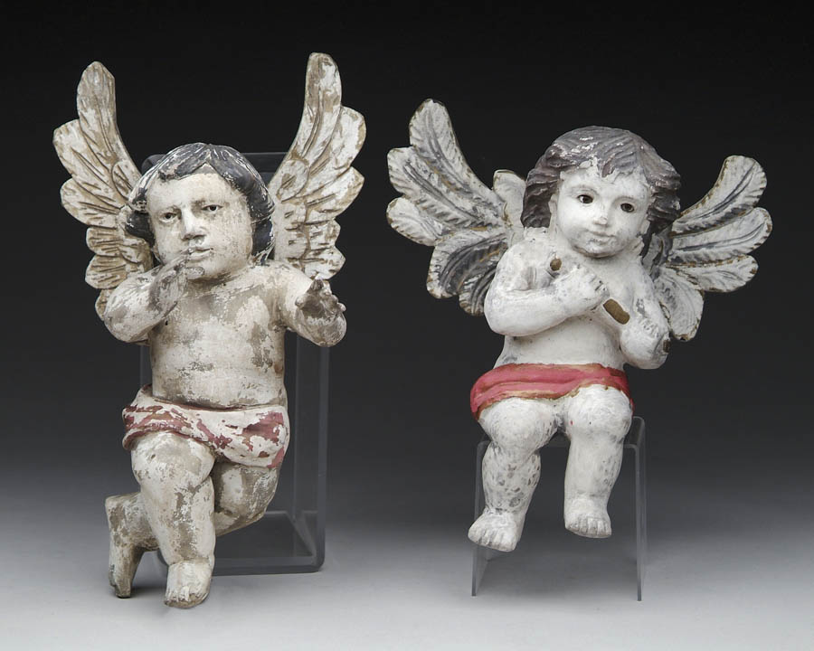 Appraisal: PAIR OF CARVED AND PAINTED WOOD PUTTI Each small figure