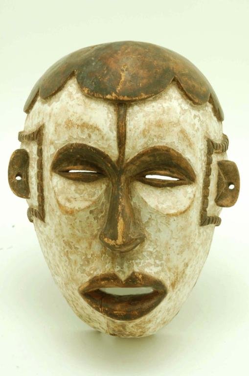 Appraisal: Carved wood face mask possibly Punu Gabon Ovoid face with