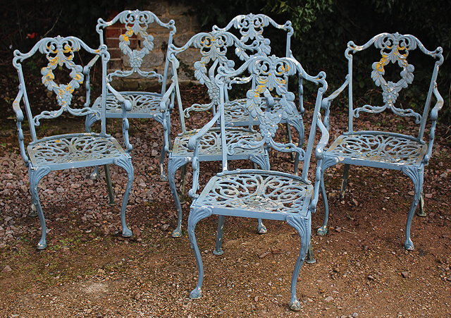 Appraisal: A SET OF SIX CAST ALUMINIUM GARDEN OPEN ARMCHAIRS painted