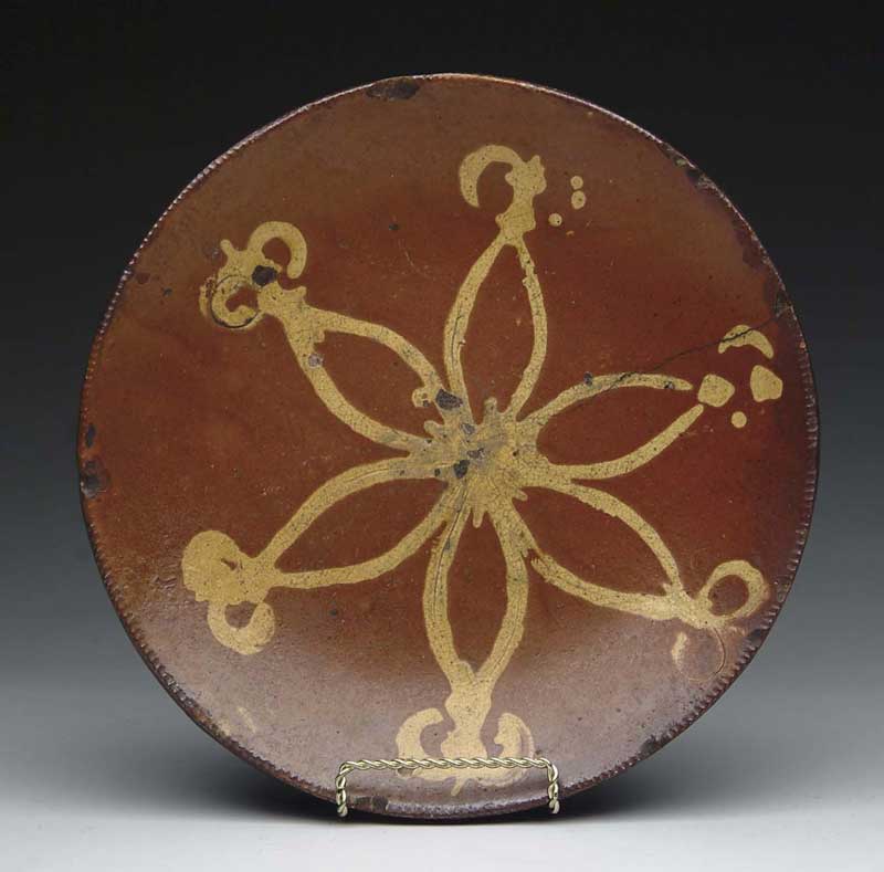 Appraisal: REDWARE SLIP DECORATED PLATE Shallow plate has crimped edge and