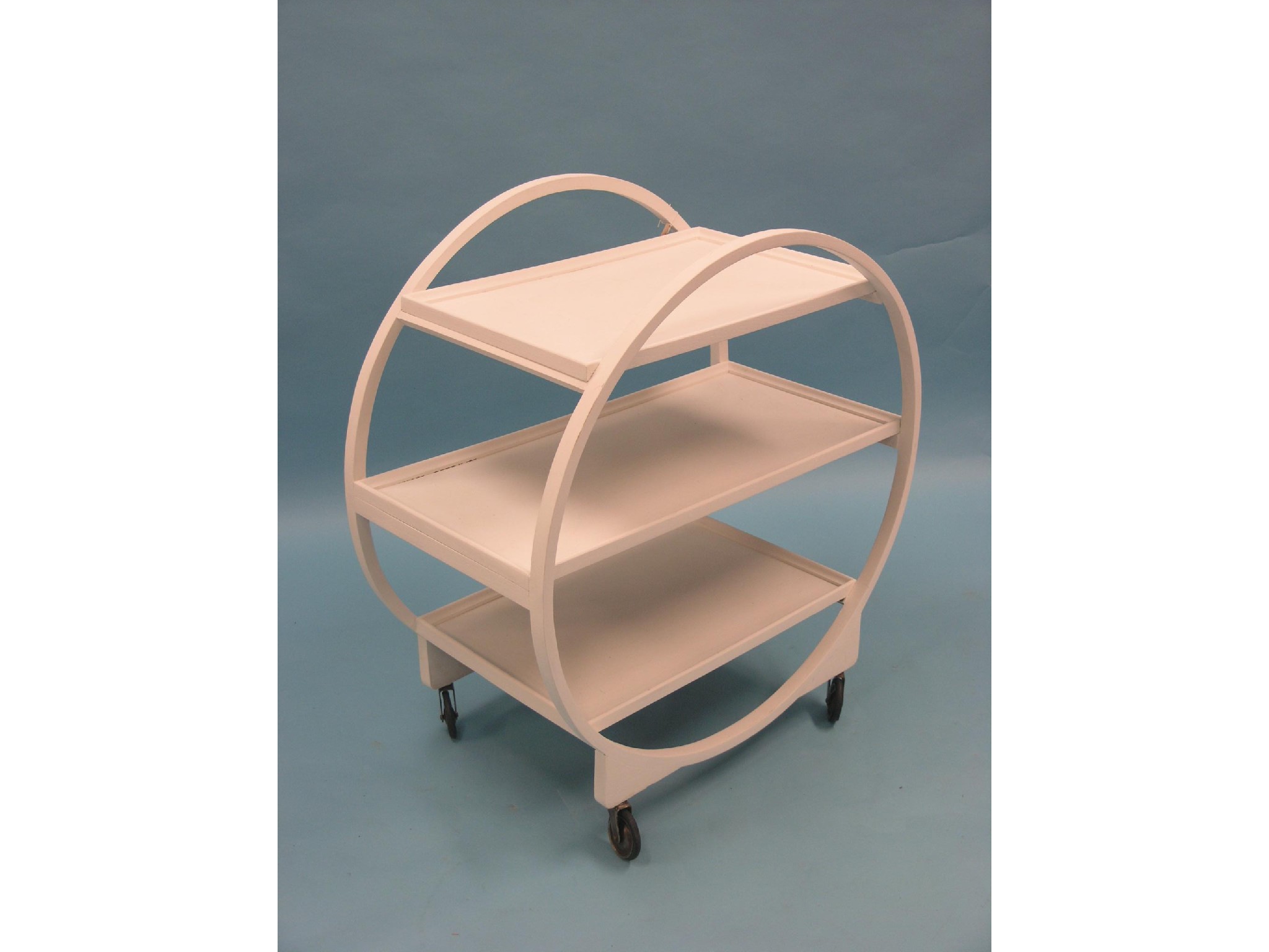 Appraisal: An Art Deco circular three-tiered trolley now white-painted on casters