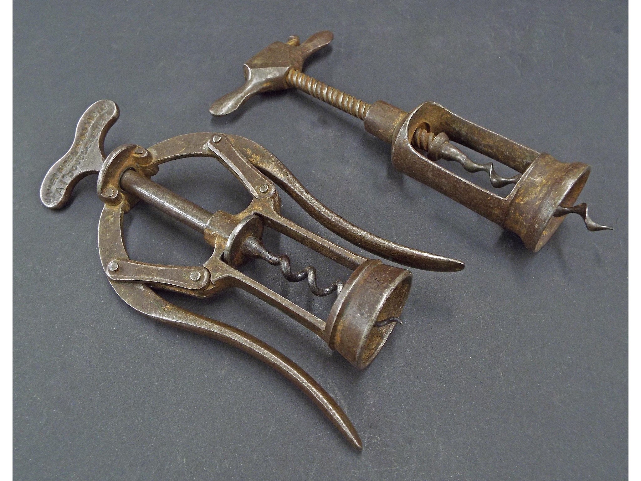 Appraisal: Two antique iron corkscrews one marked James Fealy Sons Ltd