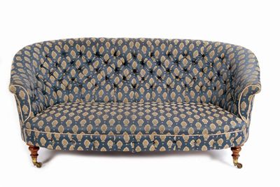 Appraisal: A Victorian settee with a wrap-round buttoned back to an