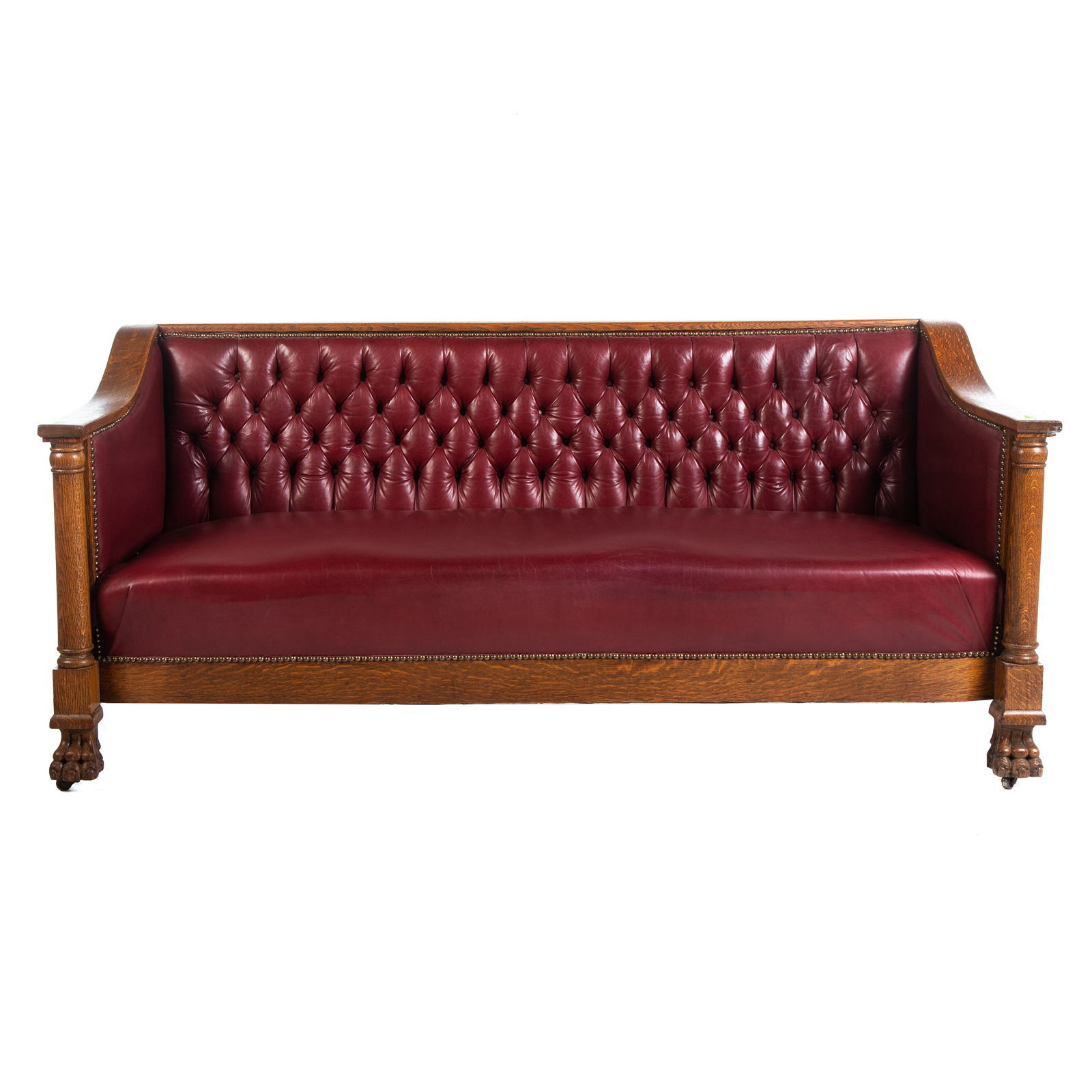 Appraisal: LATE AMERICAN CLASSICAL STYLE OAK LEATHER SOFA Circa with tufted